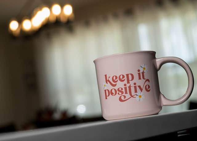 Coffee cup with 'keep it positive' message